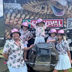 SURVIVAL Managing Director, Mike Tyrell, with his family in front of their caravan.